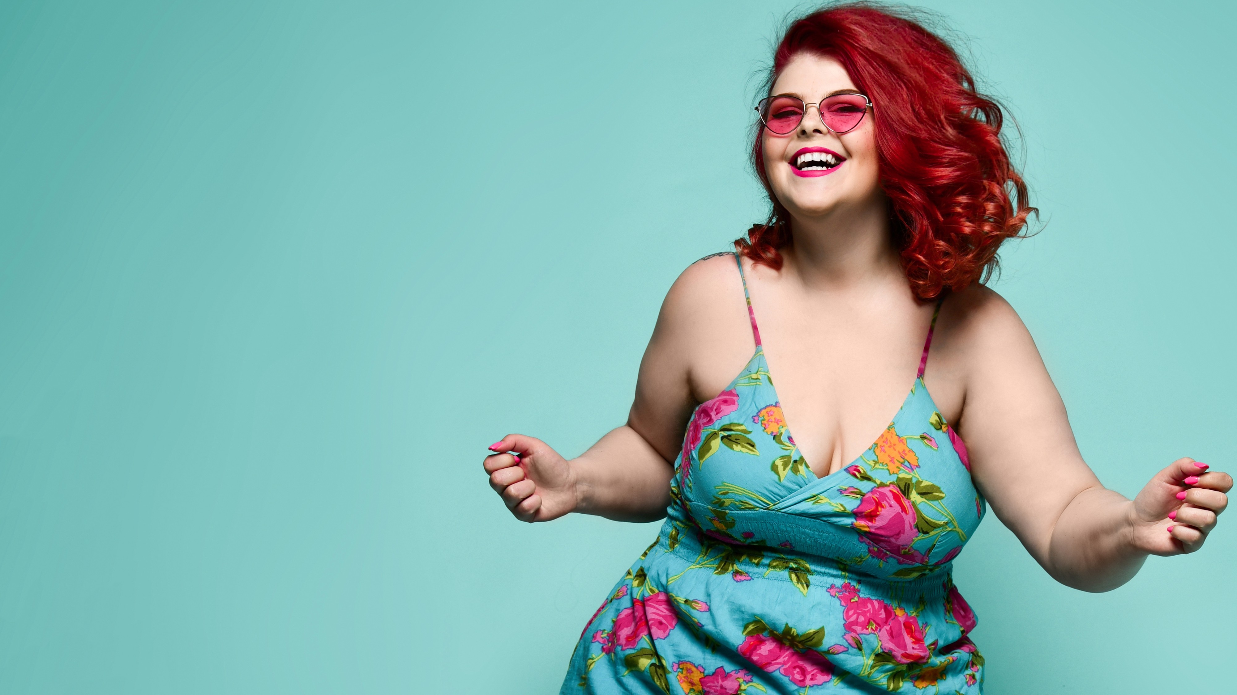 woman in colorful floral dress dancing