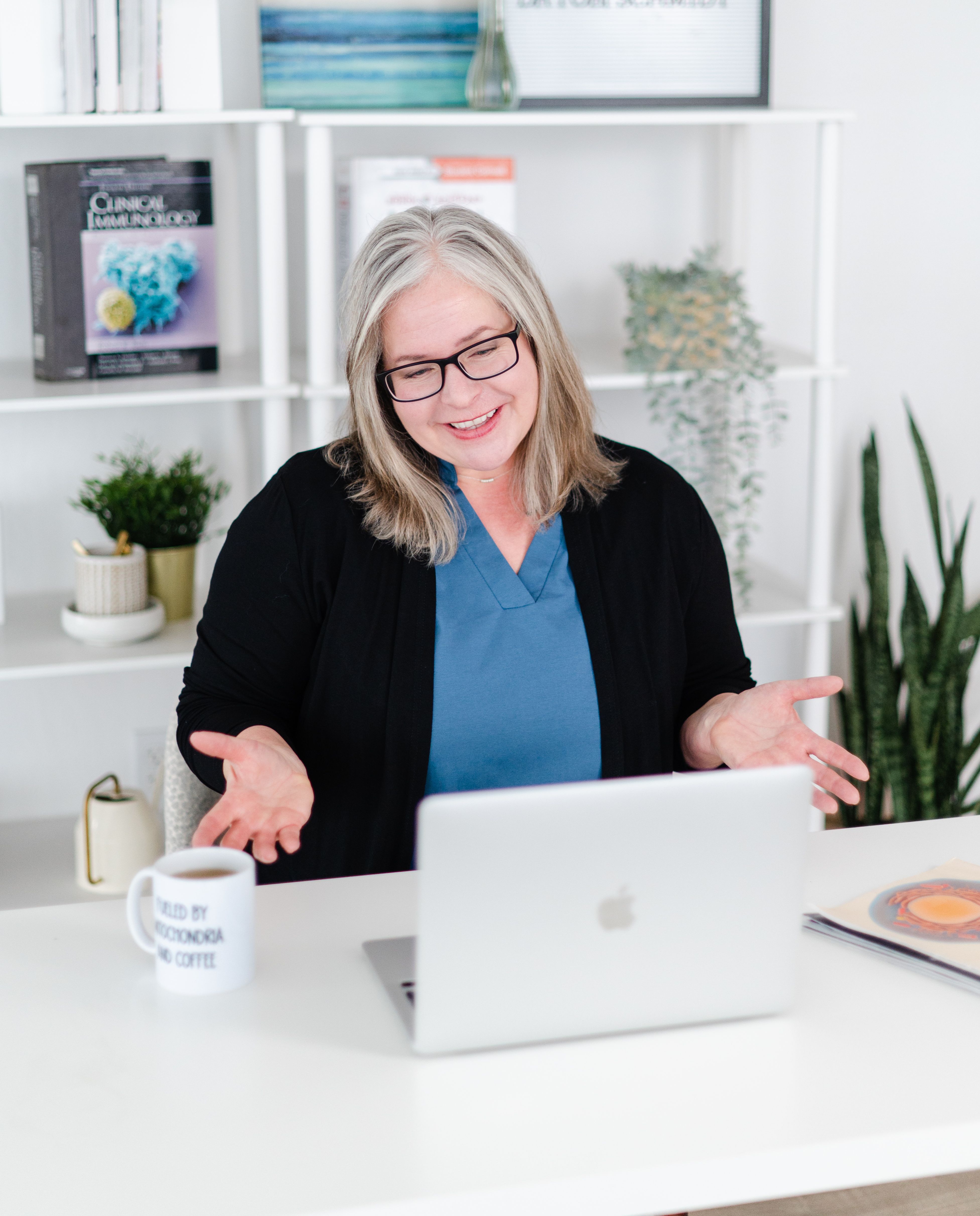 Dr. Tobi Schmidt sitting at desk smiling