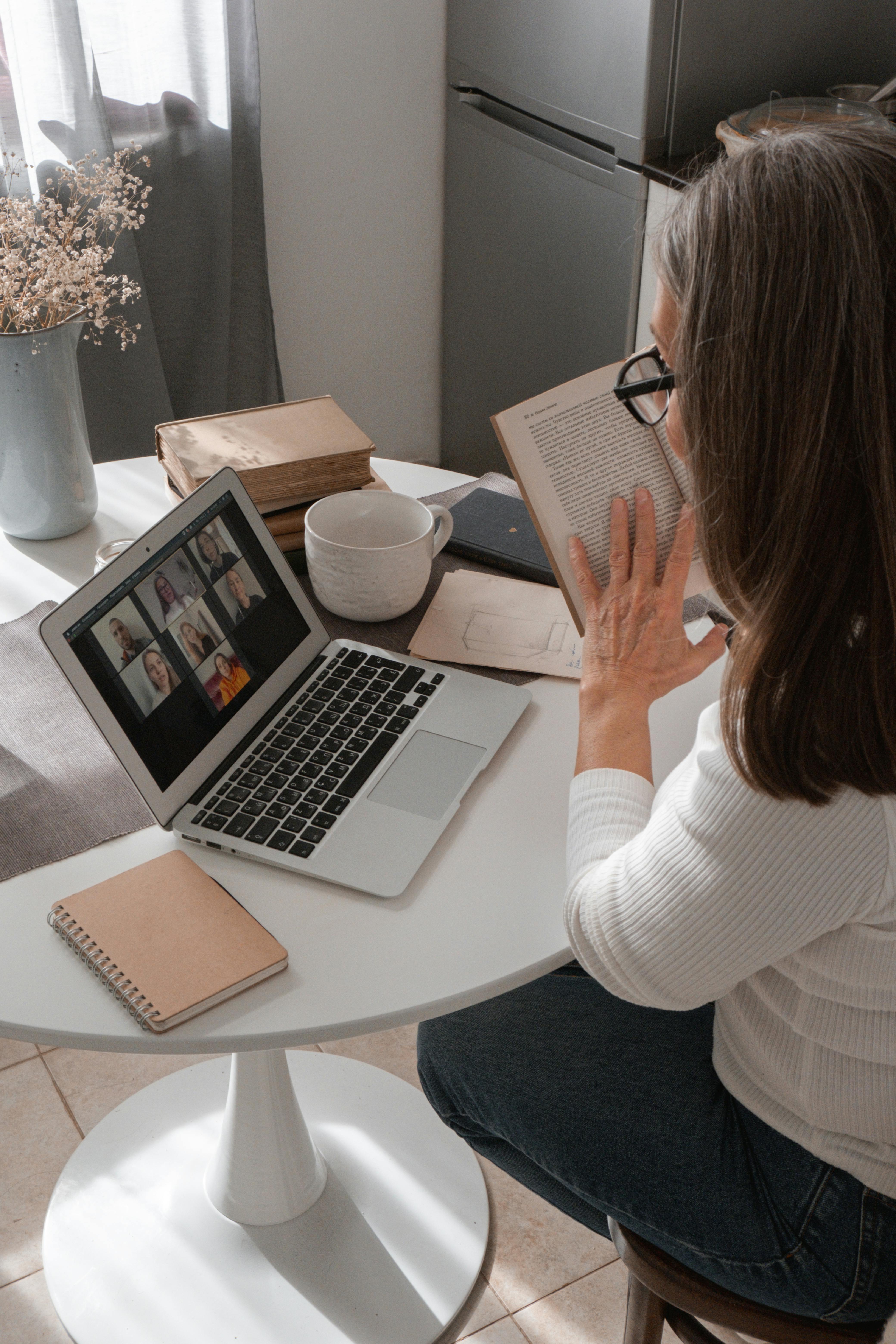 Photo by cottonbro studio: https://www.pexels.com/photo/woman-sitting-at-a-table-with-a-book-in-her-hand-and-using-a-laptop-5486101/