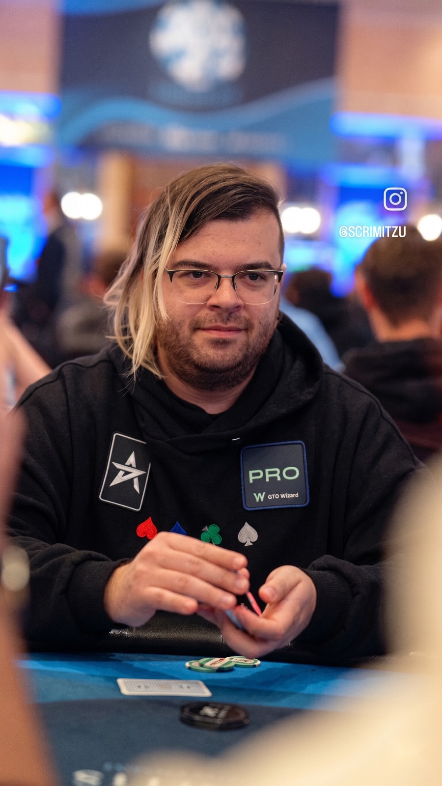 Professional poker coach Scrimitzu sitting at a final table stack during a live poker tournament event