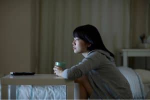 a bedtime procrastinator watches the tv at night 