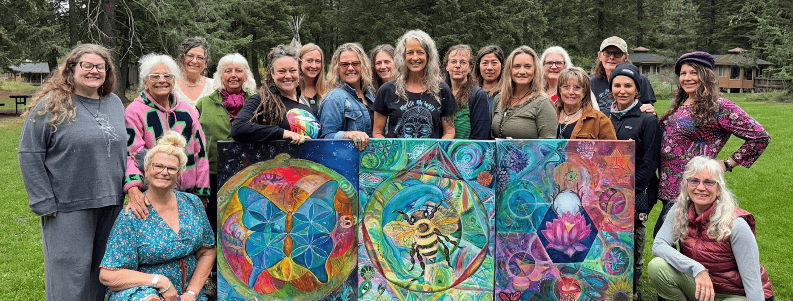 Women gathered at the Joseph retreat with three vibrant collaborative paintings.