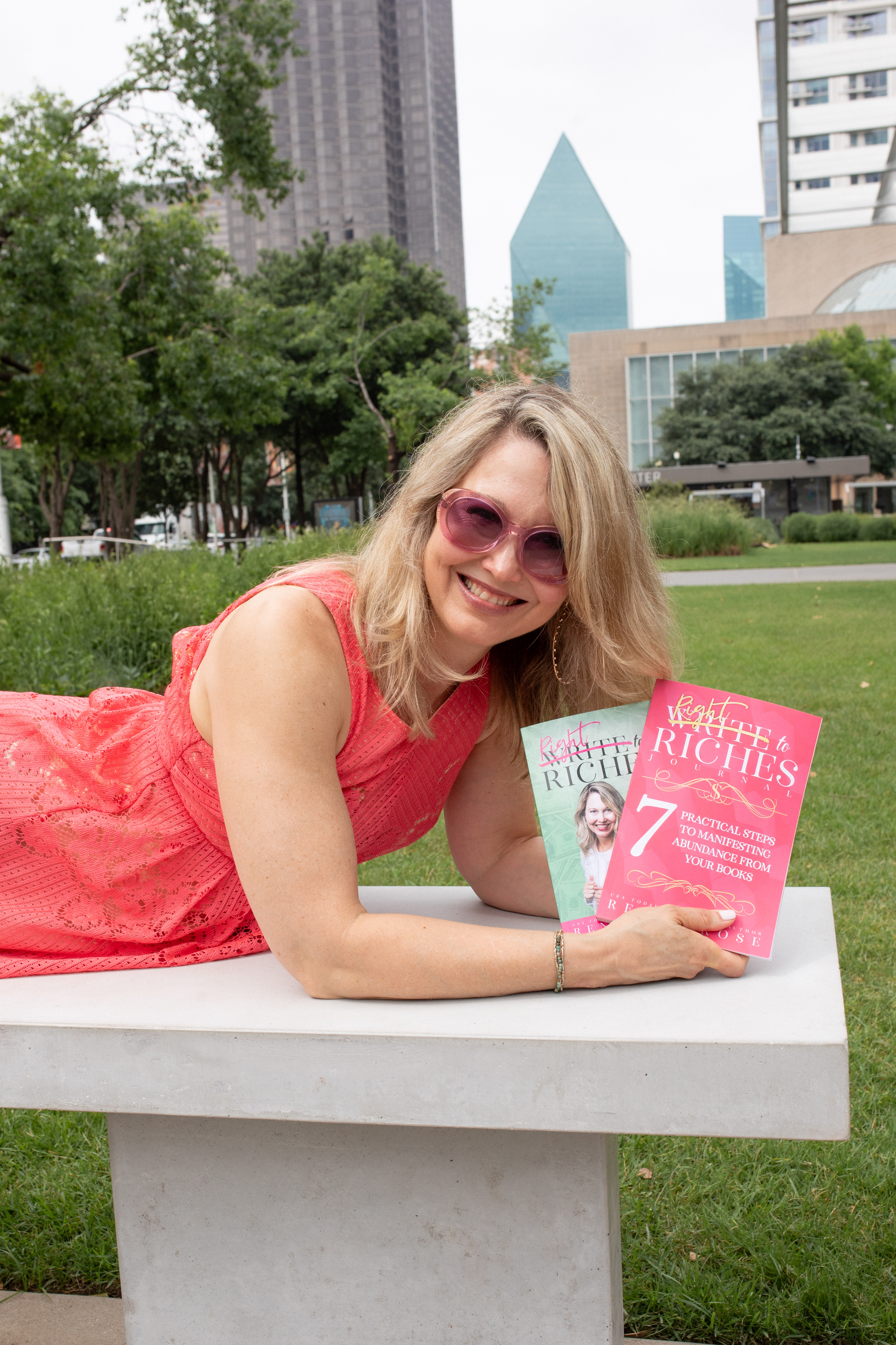 Renee on bench with Write to Riches books