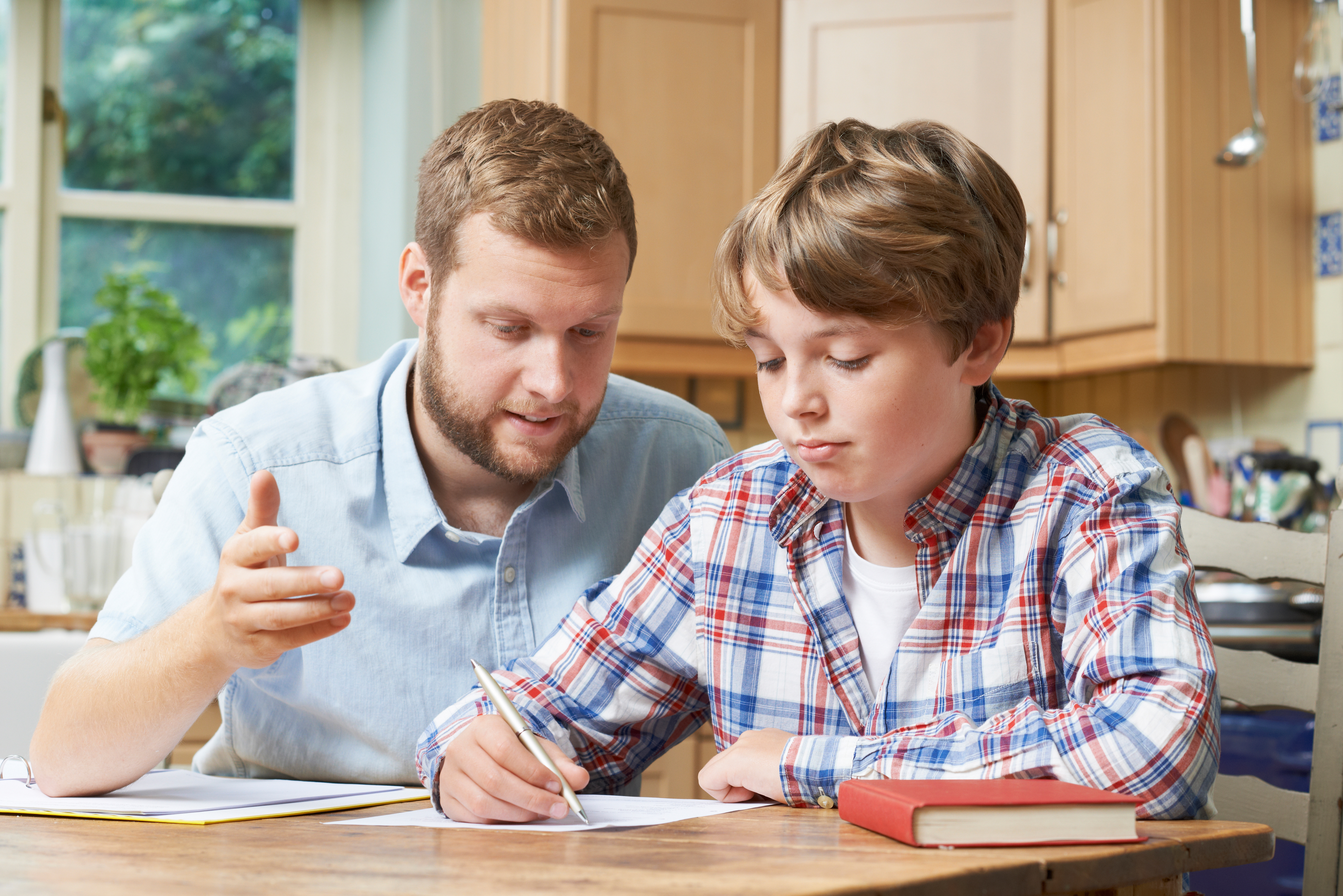 dad doing homework with his son
