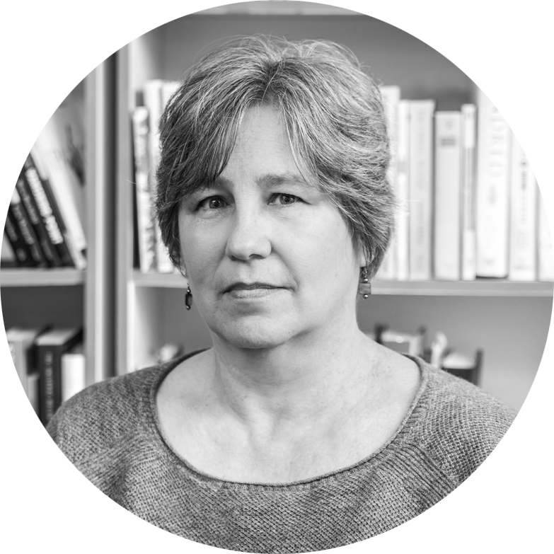 Sallie Tisdale standing in front of a bookshelf