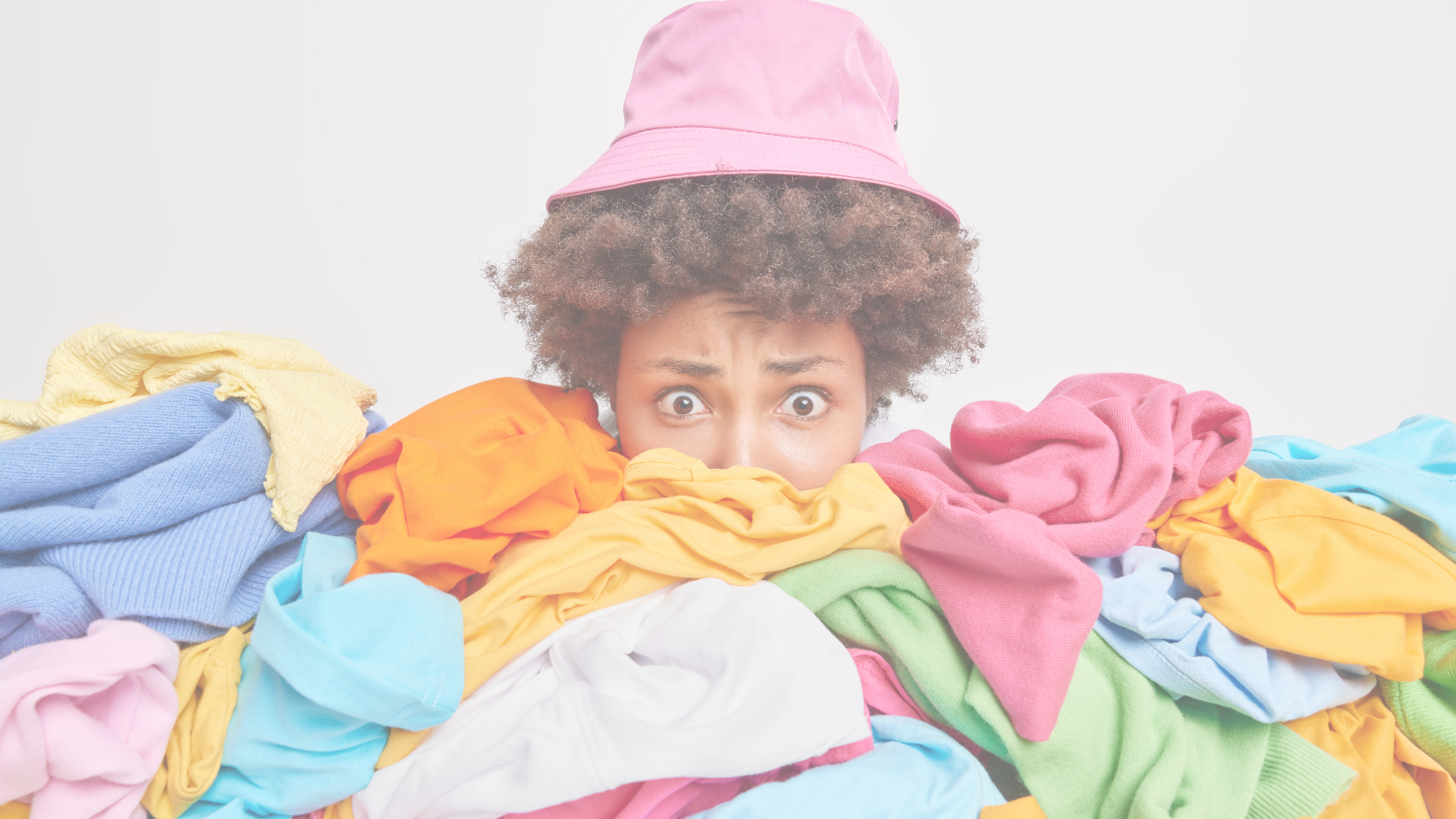 a person surrounded by a heap of clothes