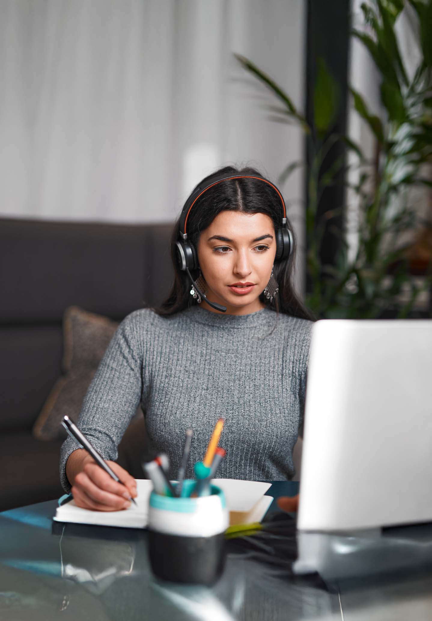 Student listening to online course at computer