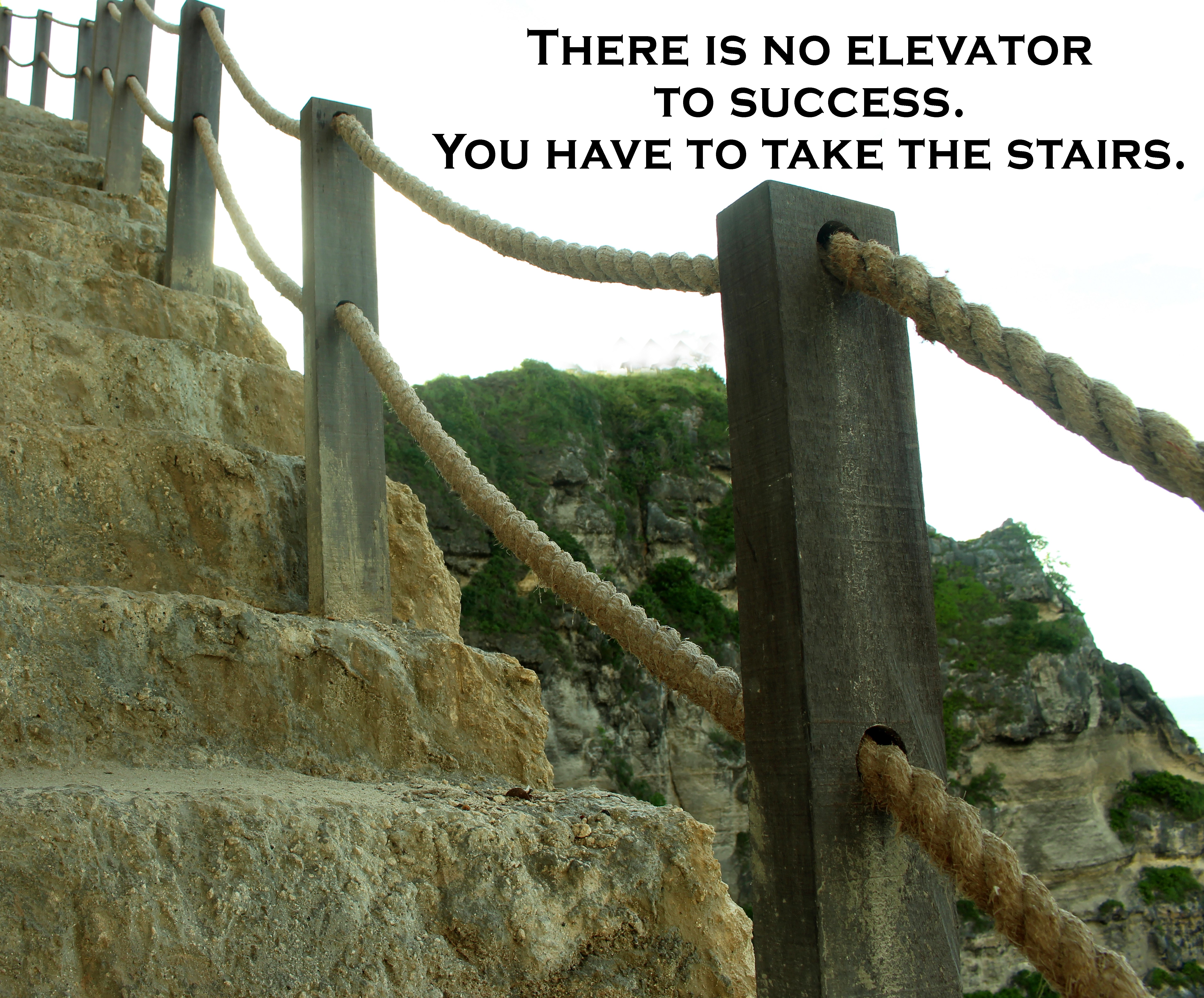 an old set of stairs carved into a mountain heading upward with the message there is no elevator to success. you have to take the stairs.