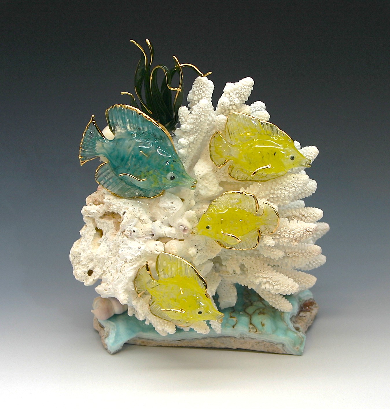 Tangs on white coral and stone base