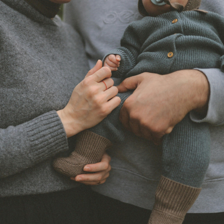 parents holding newborn after taking Let Mommy Sleep class