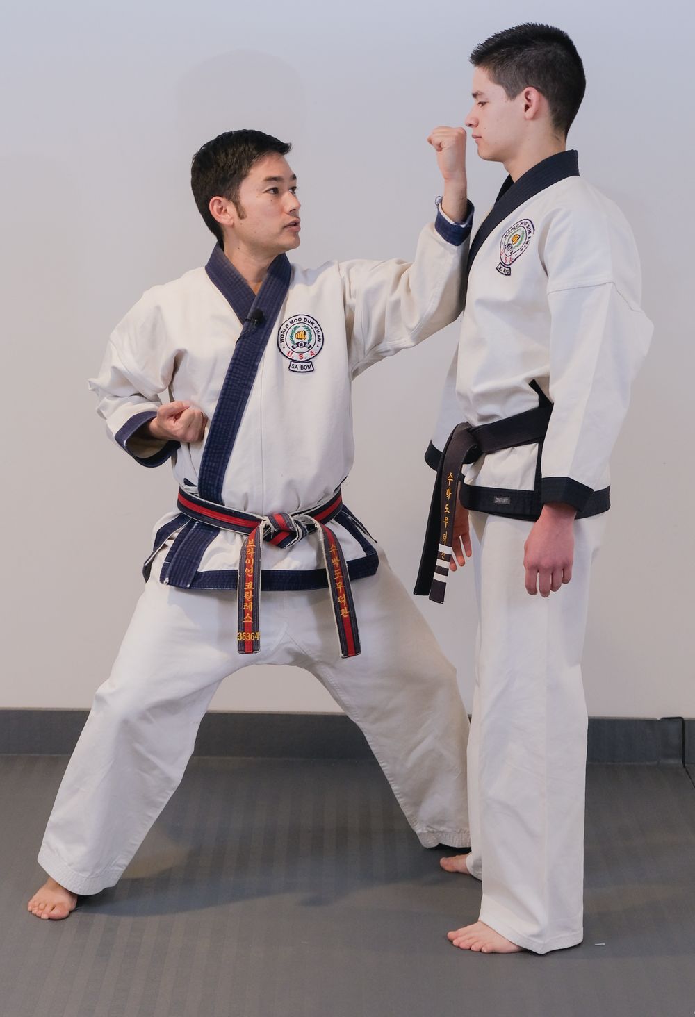 Sa Bom Corrales demonstrating one-step sparring technique with a student
