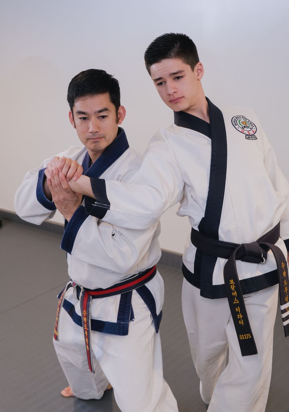 Sa Bom Corrales demonstrating a wrist-grab self-defense technique with a student