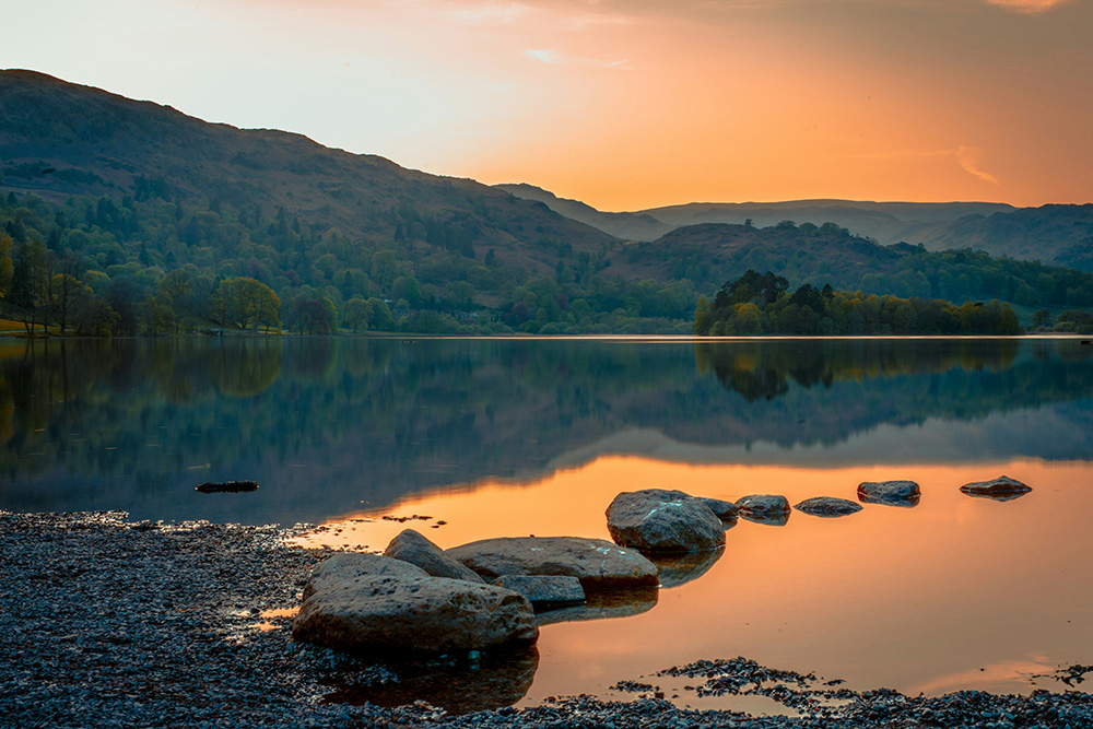 Sunset over a lake with stepping stones
