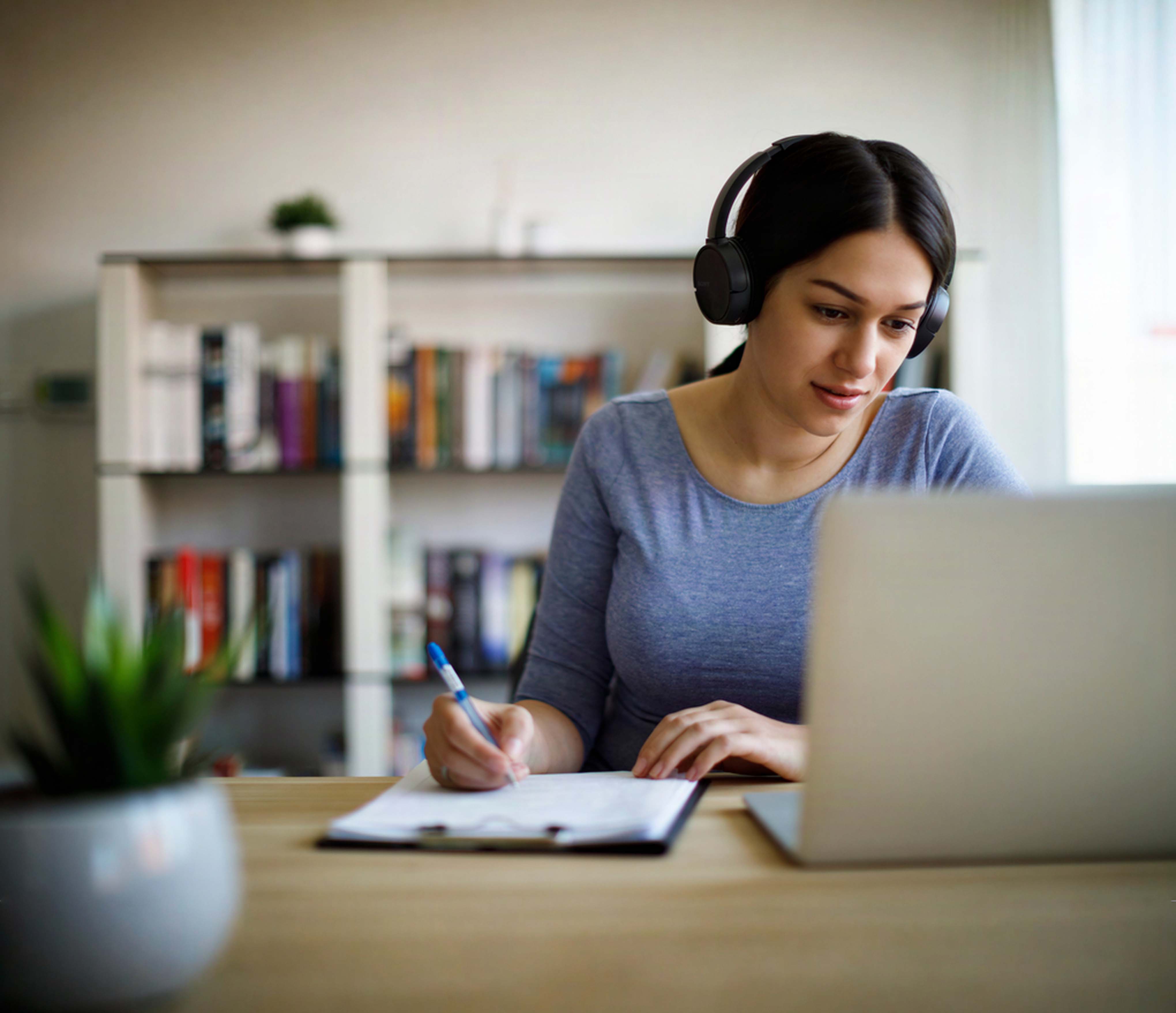 Student listening to online course at computer