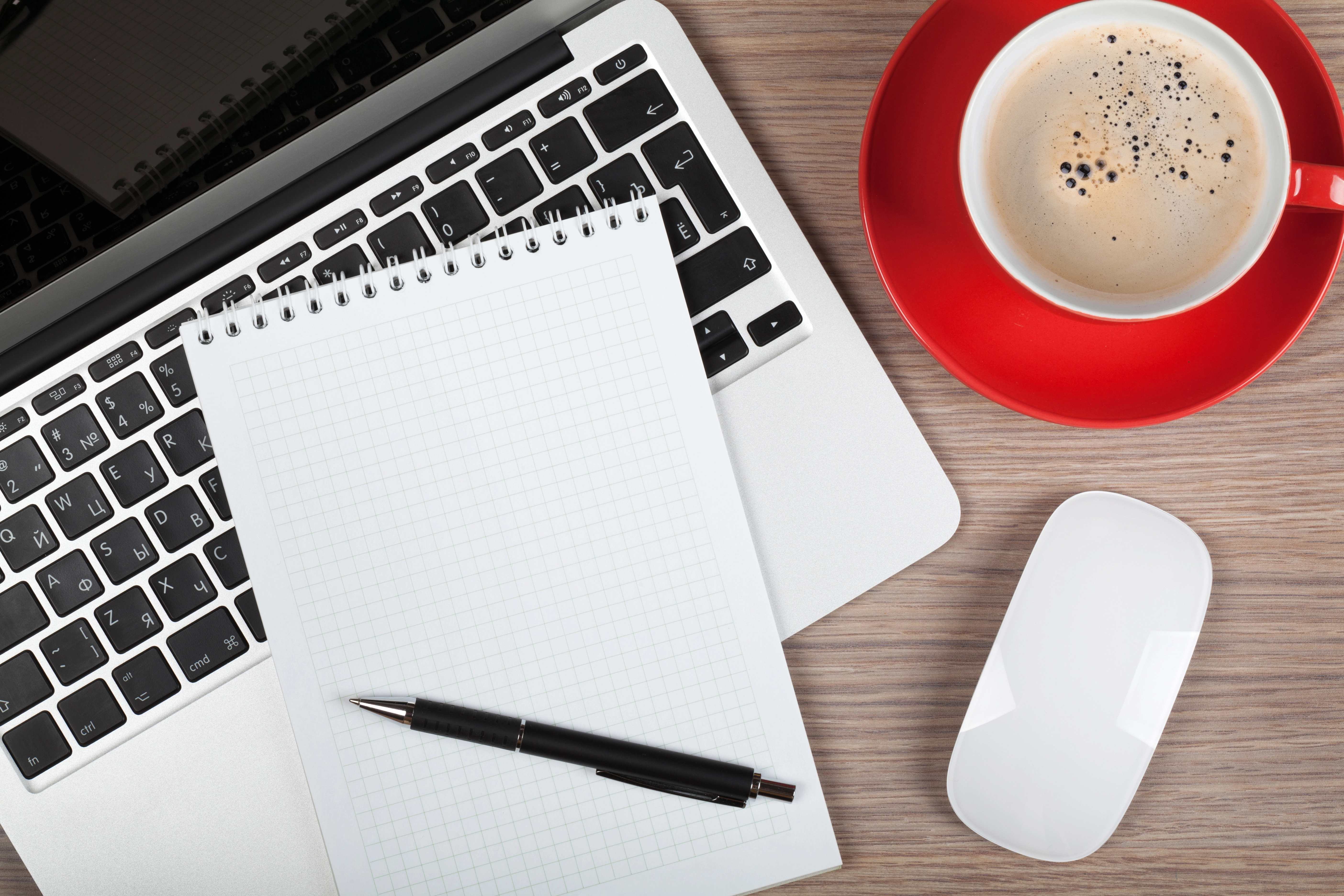 laptop with notepad and coffee