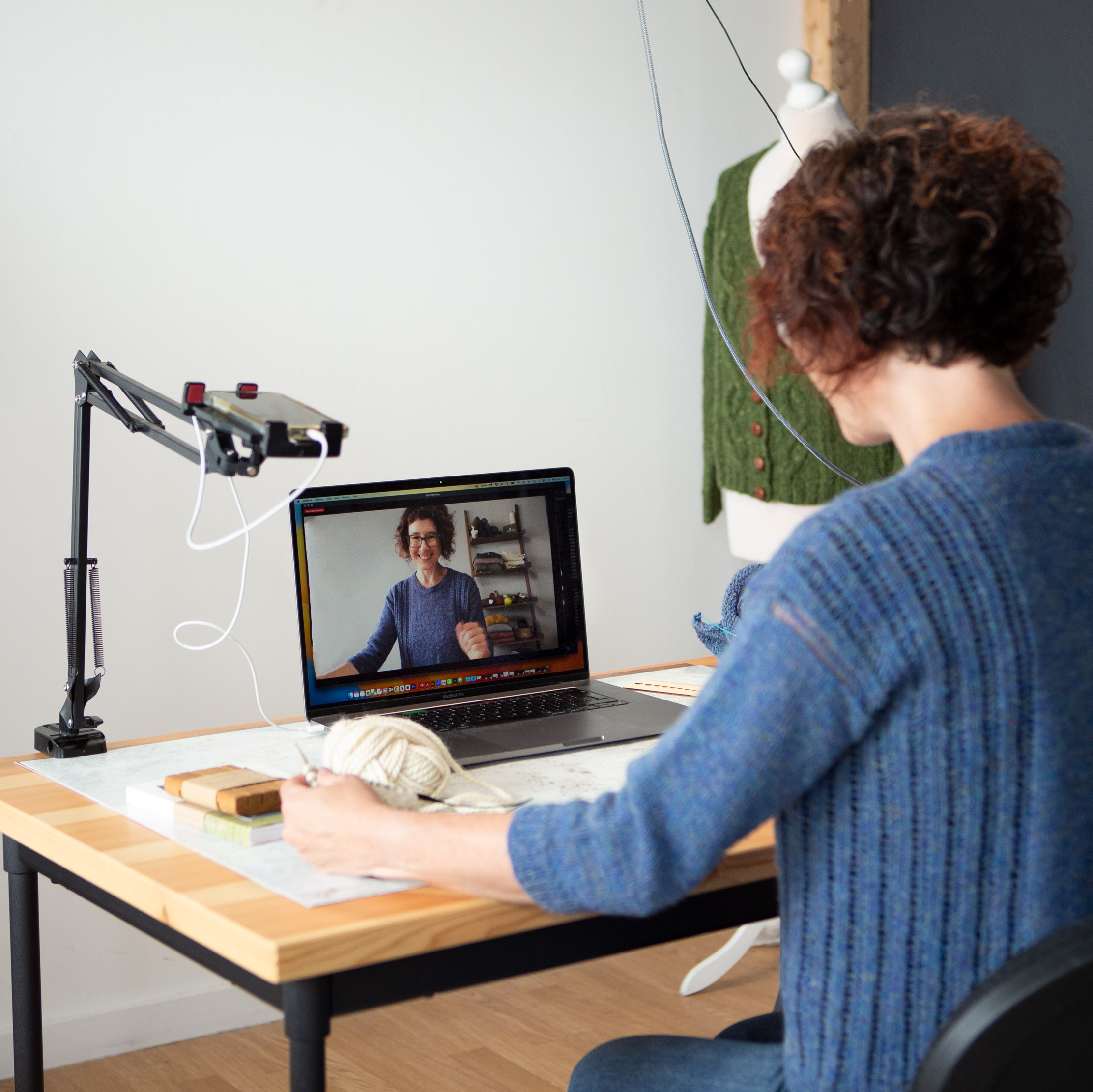 Carol Feller talking to the camera on her computer at a desk.